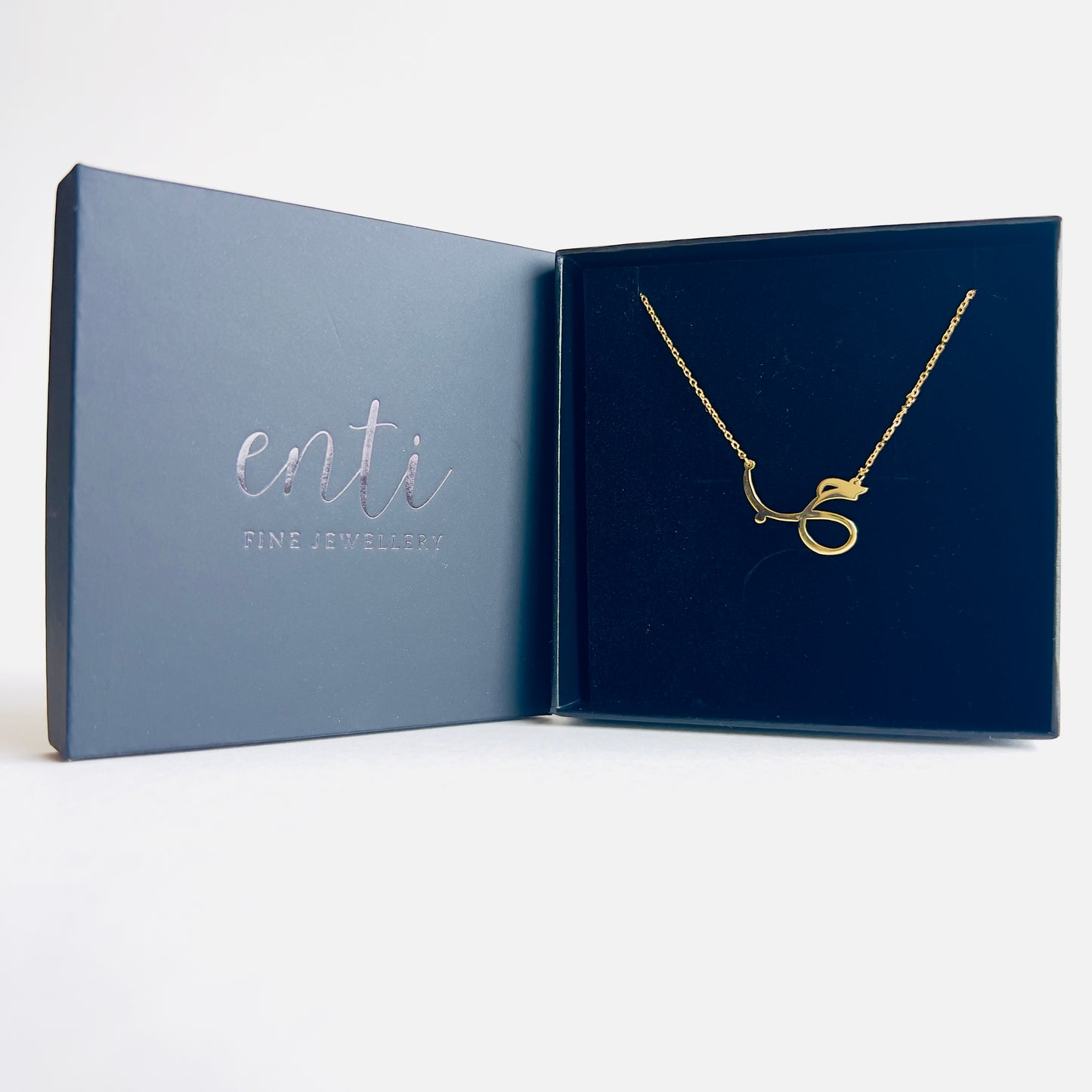 Gold chain with pendant featuring Arabic calligraphy of the word "love".