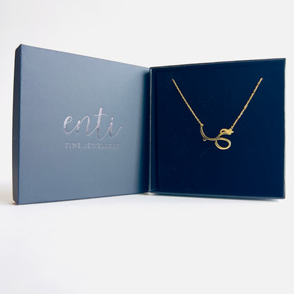 Gold chain with pendant featuring Arabic calligraphy of the word "love".