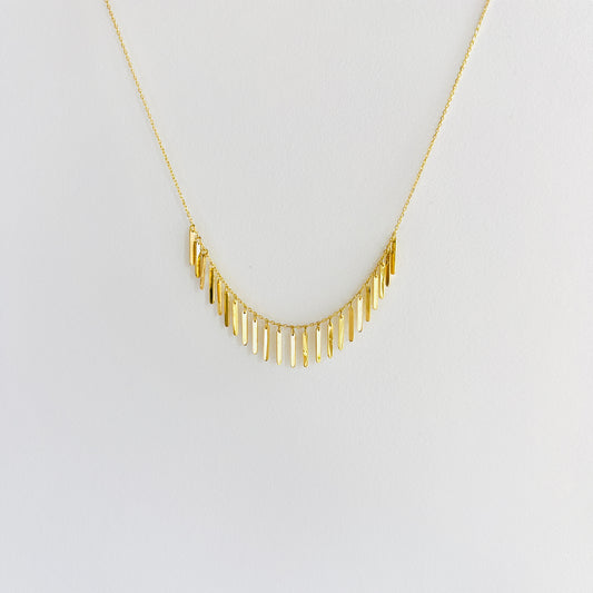 Enti Samira necklace, handmade in 18k gold with small light-catching pendants and gold chain, displayed on white background